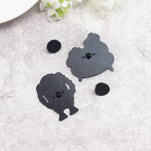 Detail view of the matte black metal back of character pins with rubber clutches