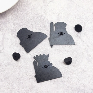 Detail of creative metal brooch backs with double-needle pins and black rubber clutches