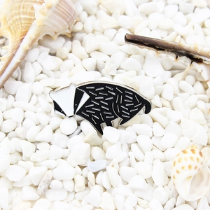 Cute black and white badger enamel brooch with silver finish on natural stones