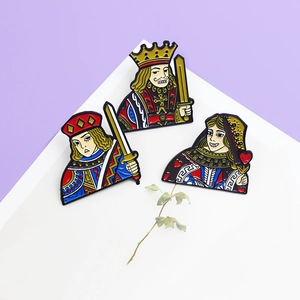 Close-up of vintage poker card enamel pins featuring King, Queen, and Jack designs
