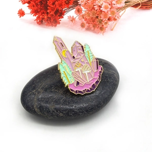 Fantasy crystal castle enamel brooch with mushrooms and moon on a black pebble background