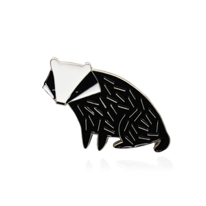 Cute badger enamel pin with black and white stripes and silver metal details