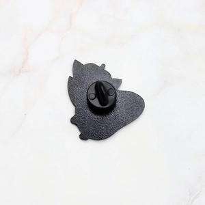 Detail view of the textured alloy back and black rubber clutch for secure pin fastening