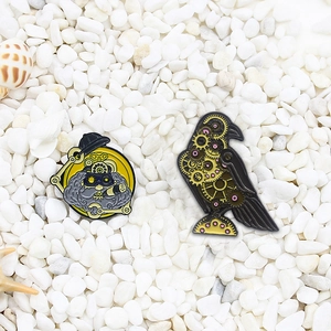 Steampunk enamel pins with bearded man and mechanical bird gear design on white stones