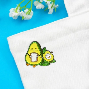 Creative avocado with toast enamel pin pinned on a white canvas bag with blue background