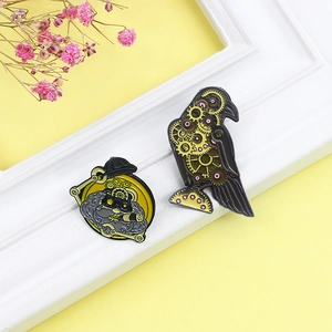 Steampunk gear bird and bearded figure enamel brooch pins on a clean white display frame