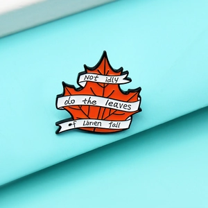 Enamel maple leaf brooch featuring the quote Not idly do the leaves of Lorien fall