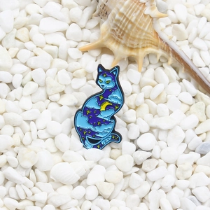 Starry sky cat enamel brooch with moon and cloud patterns on white pebble background