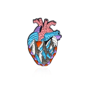 Artistic anatomical heart enamel brooch featuring a mountain and river landscape design