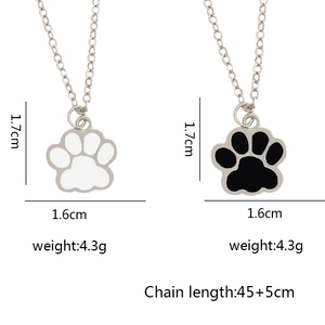 Minimalist animal paw pendant necklace in black and white colors with adjustable silver chain