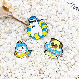 Cartoon animal enamel pins featuring polar bear, unicorn and dog with swim rings