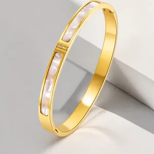 Minimalist rose gold titanium steel bangle with three diamonds and shell inlay.