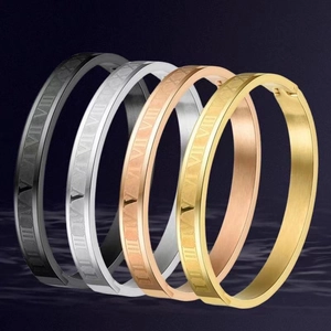 Set of premium titanium steel bangles with Roman numeral engraving in four distinct metallic finishes