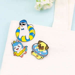 Cartoon animal enamel pins with unicorn and polar bear designs on a canvas bag
