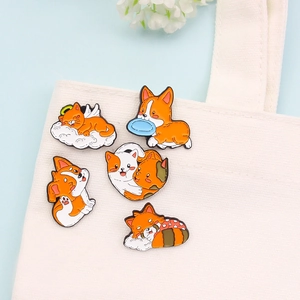 Set of five cute cartoon animal enamel pins on a white canvas bag with floral accents