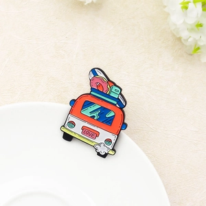 Cartoon red camper van enamel brooch with surfboards and LOVE license plate on beige background