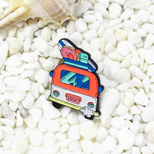 Cartoon camper van shoe charm with surfboard and LOVE plate on summer beach pebbles