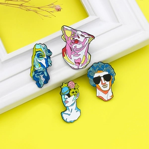 Artistic set of four abstract plaster bust pins with colorful enamel on yellow background