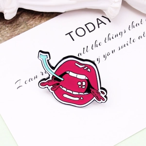 Modern enamel brooch featuring sexy red lips eating a strawberry lollipop on card