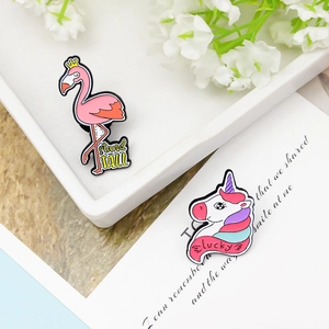 Enamel flamingo and unicorn pins with stand tall and lucky text for trendy outfits