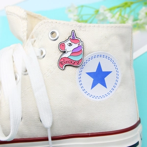 Cute unicorn enamel pin with lucky engraving on a stylish white canvas sneaker