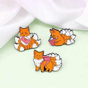 Three orange cartoon nine-tailed fox enamel pins with love letter and book designs