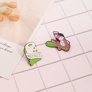 Creative enamel pin set featuring toilet paper and toothbrush designs on white tiles
