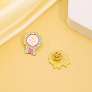 Enamel Best Mum Ever medal brooch with mint green ribbon and gold butterfly clutch