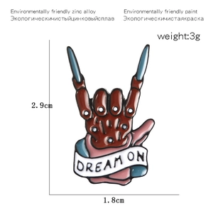 Rock hand skull enamel pin with red bones and Dream On ribbon slogan on zinc alloy