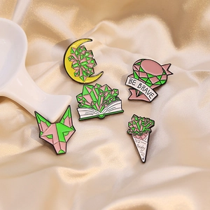 Set of five colorful crystal alloy brooches with Be Brave and It’s Friday designs