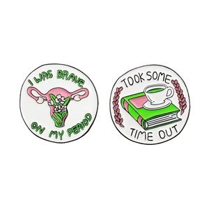 Creative enamel pin set featuring floral uterus and coffee book designs in alloy