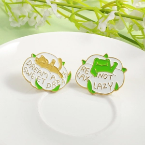 Cartoon cat and frog enamel lapel pins with sweet dream text on white ceramic tray