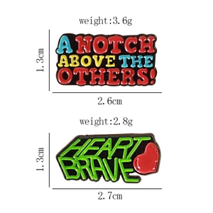 Detail view of colorful enamel letter pins with motivational phrases on white background