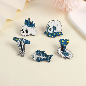 Detailed set of 5 celestial enamel pins featuring stars, moons, and skeletons on a beige background