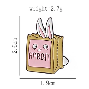 Detail showing the dimensions of the cute rabbit enamel brooch in a pink shopping bag
