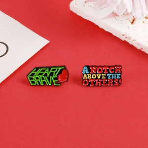 Enamel pins set with Heart Brave text and A Notch Above The Others slogan on red background