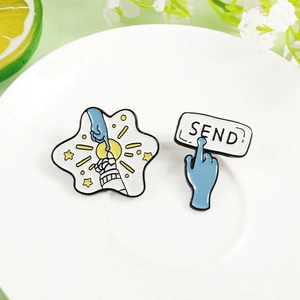 Astronaut and alien touch brooch set with blue hand reaching SEND button on a white plate