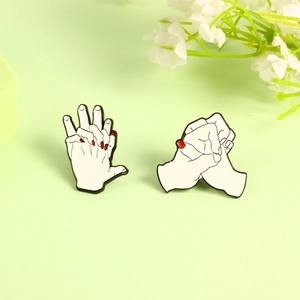 Creative enamel couple hand-holding brooches in white with red nails and black outlines