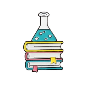 Science enamel pin featuring chemical flask on colorful books with blue liquid