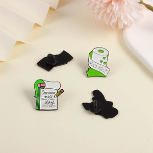 Detail of toilet paper and notebook enamel pins with rubber butterfly clutches