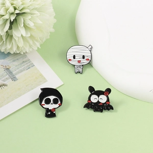 Halloween enamel pin set featuring cartoon mummy, grim reaper and vampire bat badges