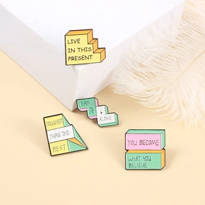 Pastel enamel lapel pin set with inspirational quotes on modern geometric shapes