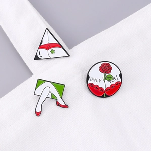 Three creative red enamel pins with rose and high heels pinned on a white canvas bag
