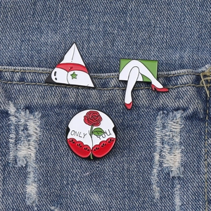 Three-piece enamel pin set with bikini, red heels and Only You rose on blue denim background