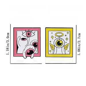 Detailed size specifications for pink and yellow cartoon enamel pins with winged eye design