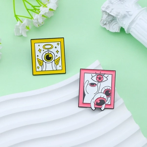 Cartoon enamel pins set featuring a pink monster and a golden halo angel on green background