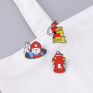 Three firefighter enamel pins with hydrant and otter on white canvas bag strap