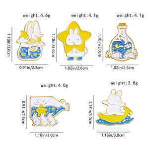 Lot de cinq broches en émail représentant des lapins blancs et étoiles avec poids et dimensions