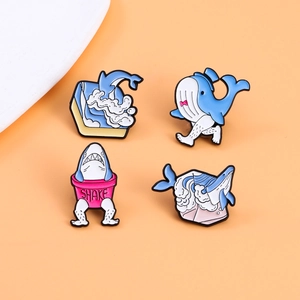 Creative whale and shark enamel pin set with quirky long legs on orange background