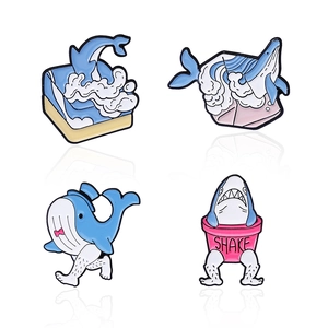 Set of four unique cartoon ocean animal enamel pins featuring whales and humor sharks